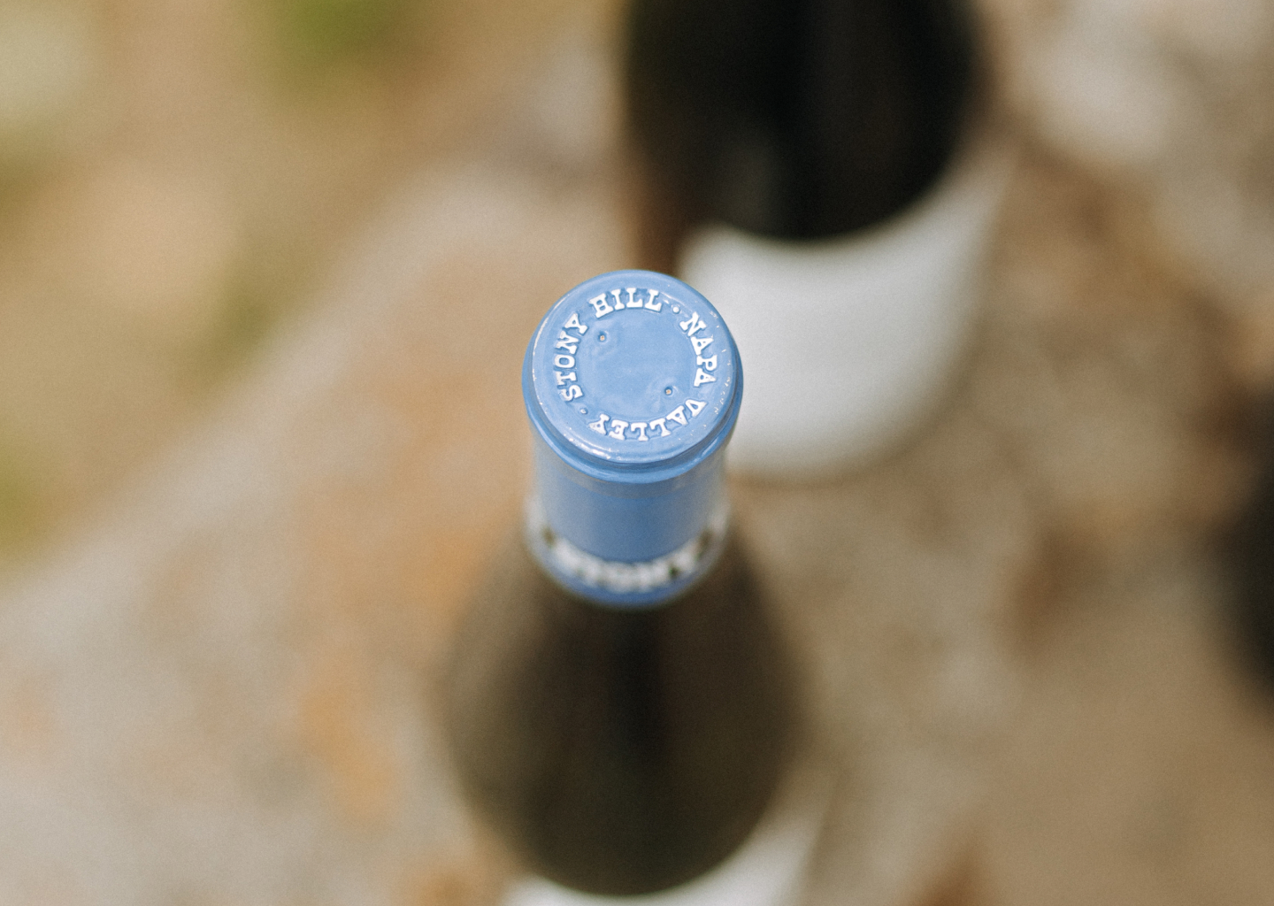 A image of a Stony Hill bottle from the top showing the bottle cap blue foil that says "Stony Hill Napa Valley"