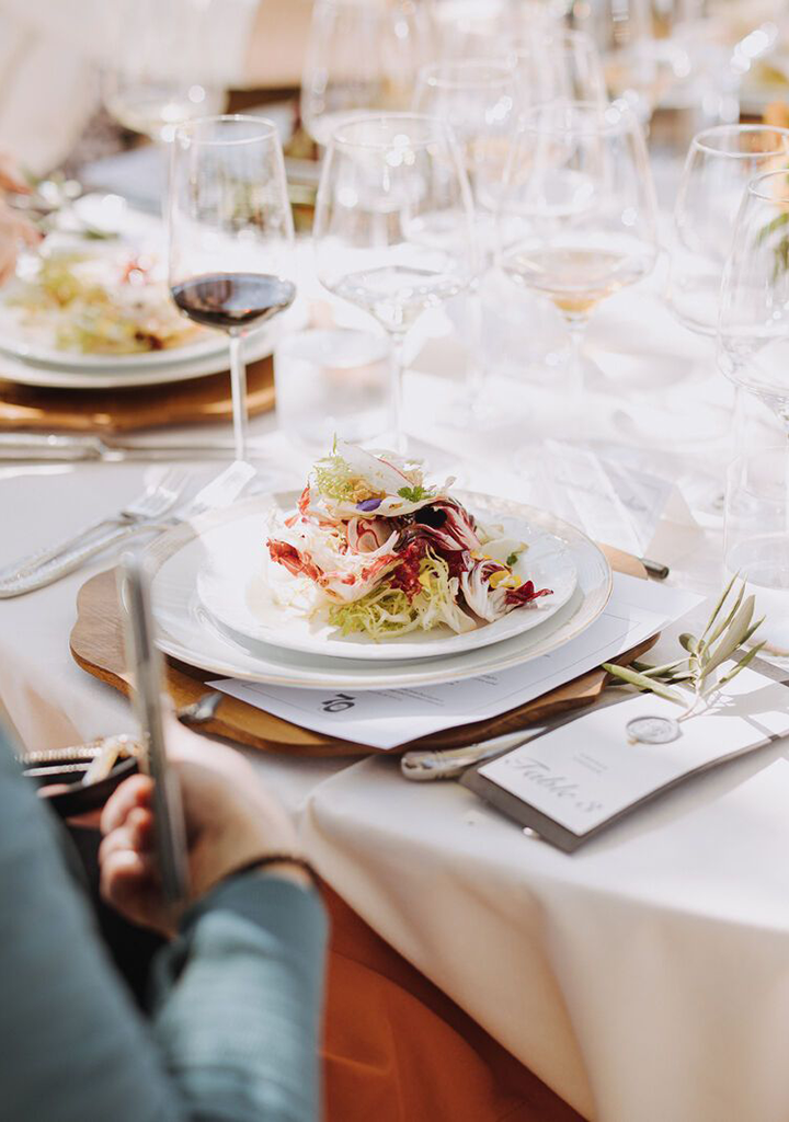 Stony Hill Harvest Luncheon | Table setting with a plate of food and a glass of wine.