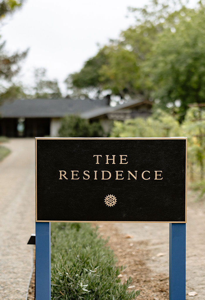 The Residence sign outside Stony Hill with the Residence home in the background.