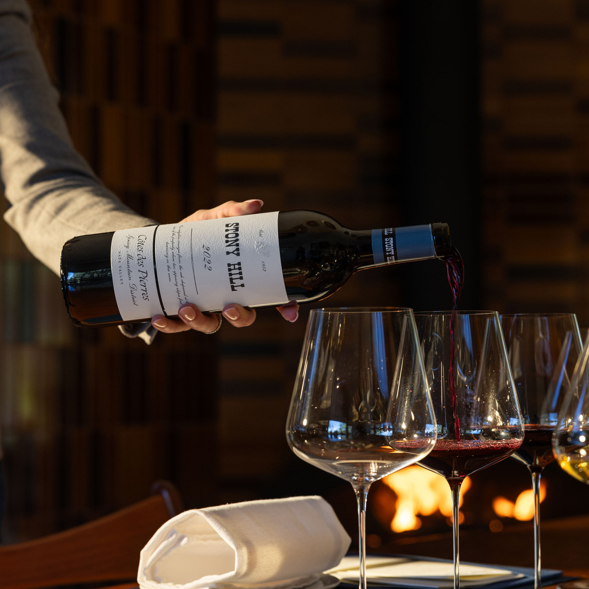 A bottle of Stony Hill Cote des Pierres being poured into a glass inside The Residence at Stony Hill