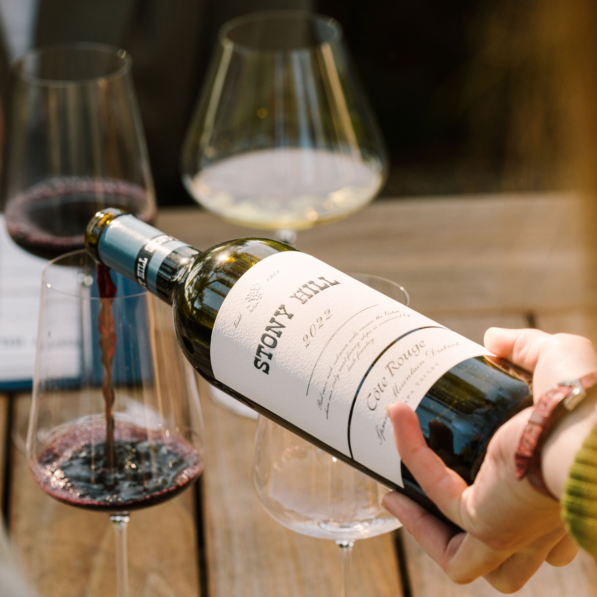 A bottle of Cote Rouge being poured into a glass at The Residence at Stony Hill