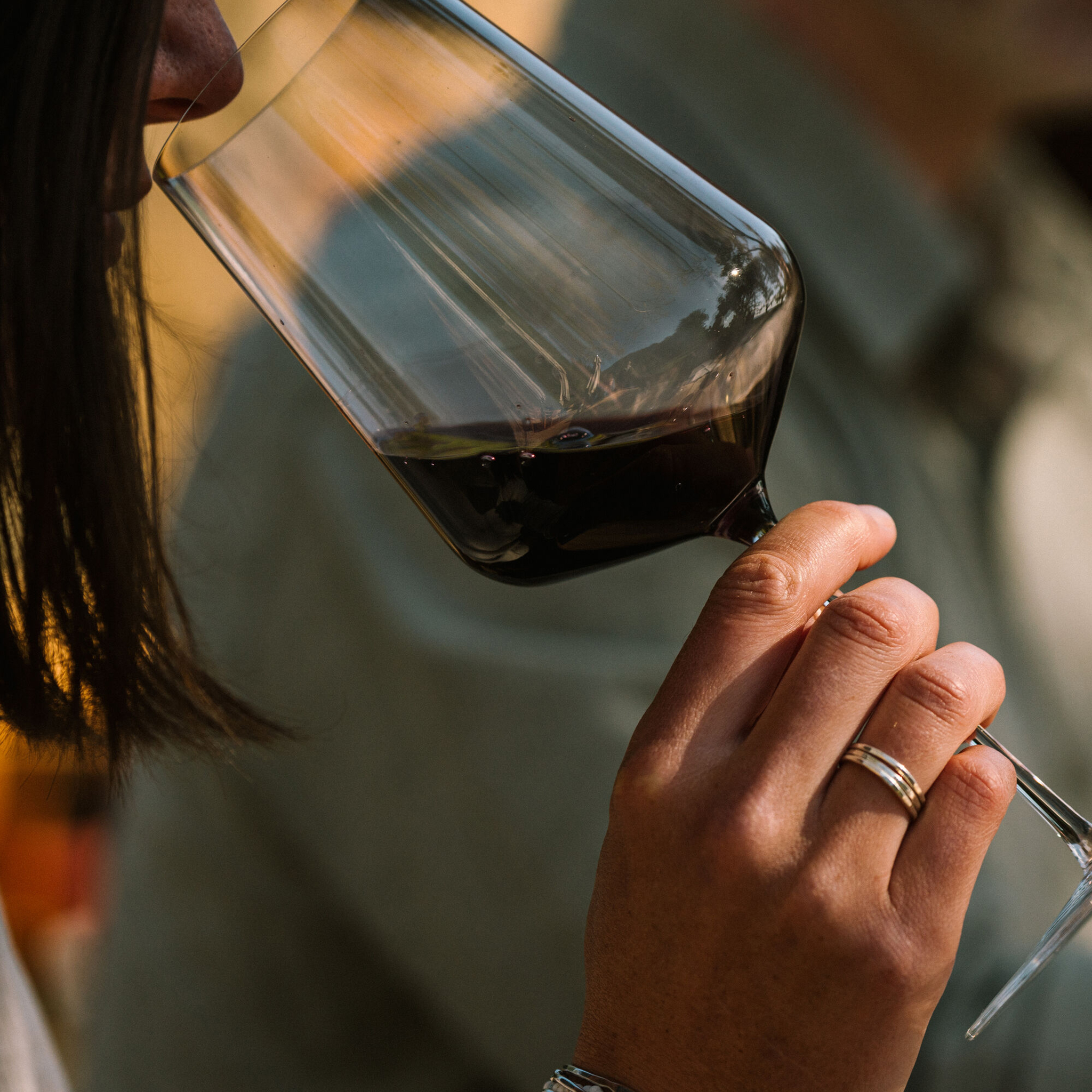 Guest sniffing a glass of red wine at The Residence.