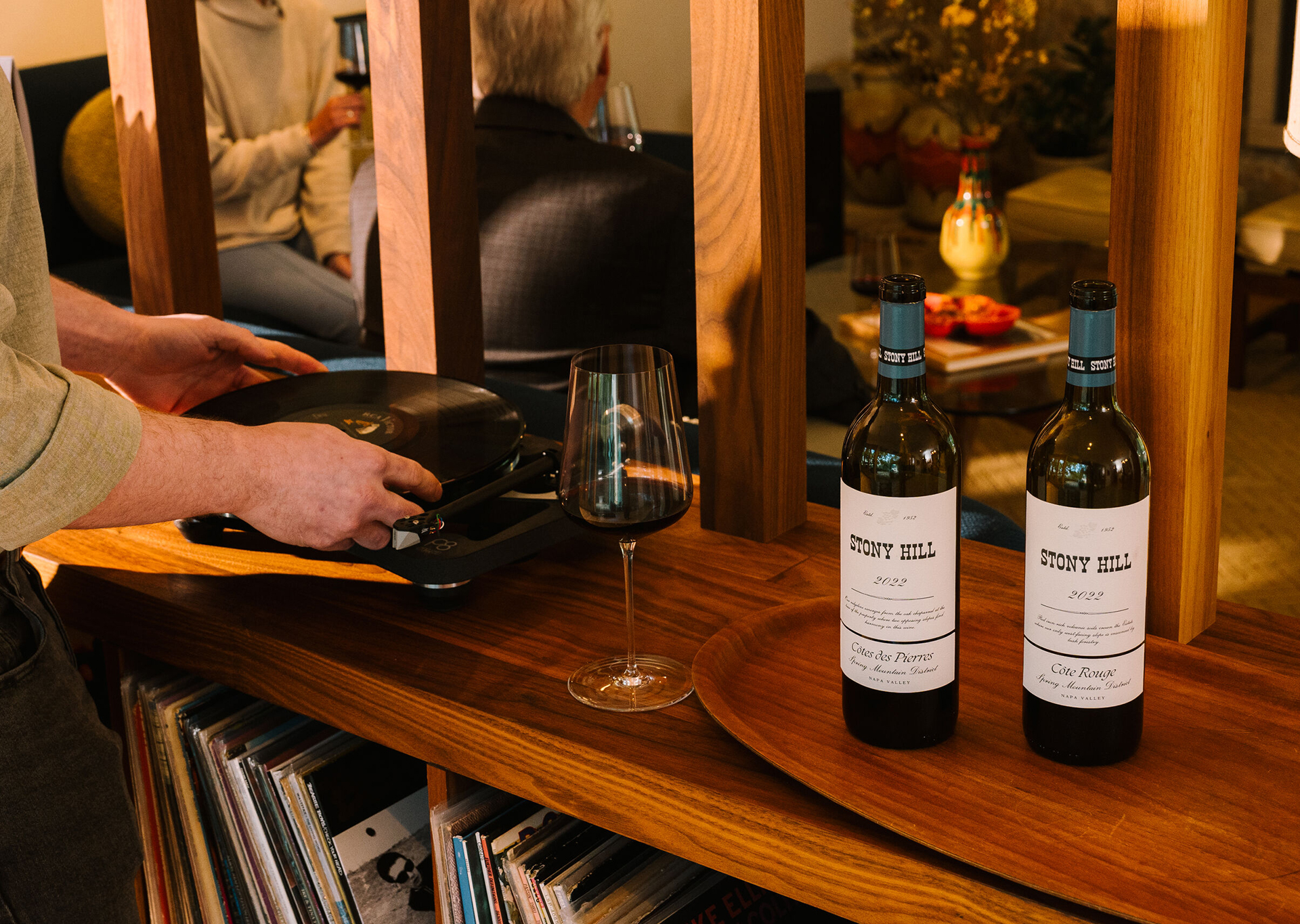 A guest playing a record inside The Residence at Stony Hill