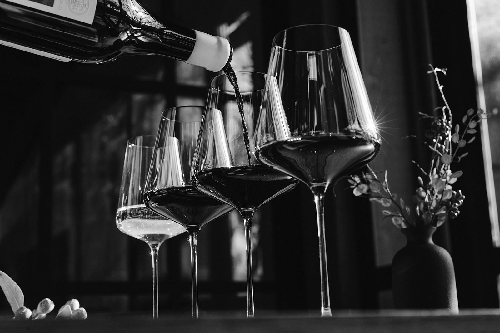 A bottle of Ink Grade being poured into a wine glass.